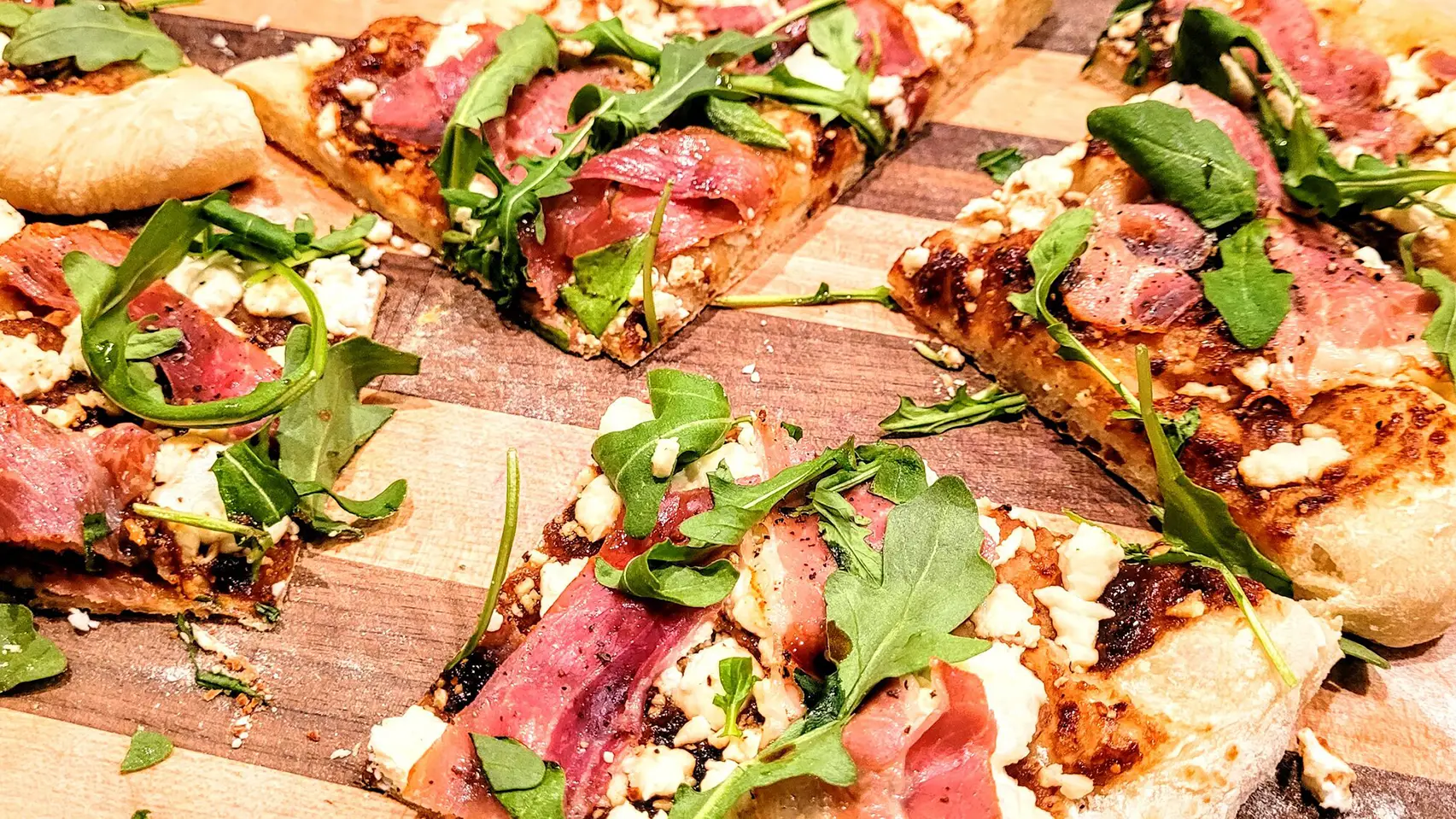Fresh goat cheese fig jamon serrano arugula pizza
