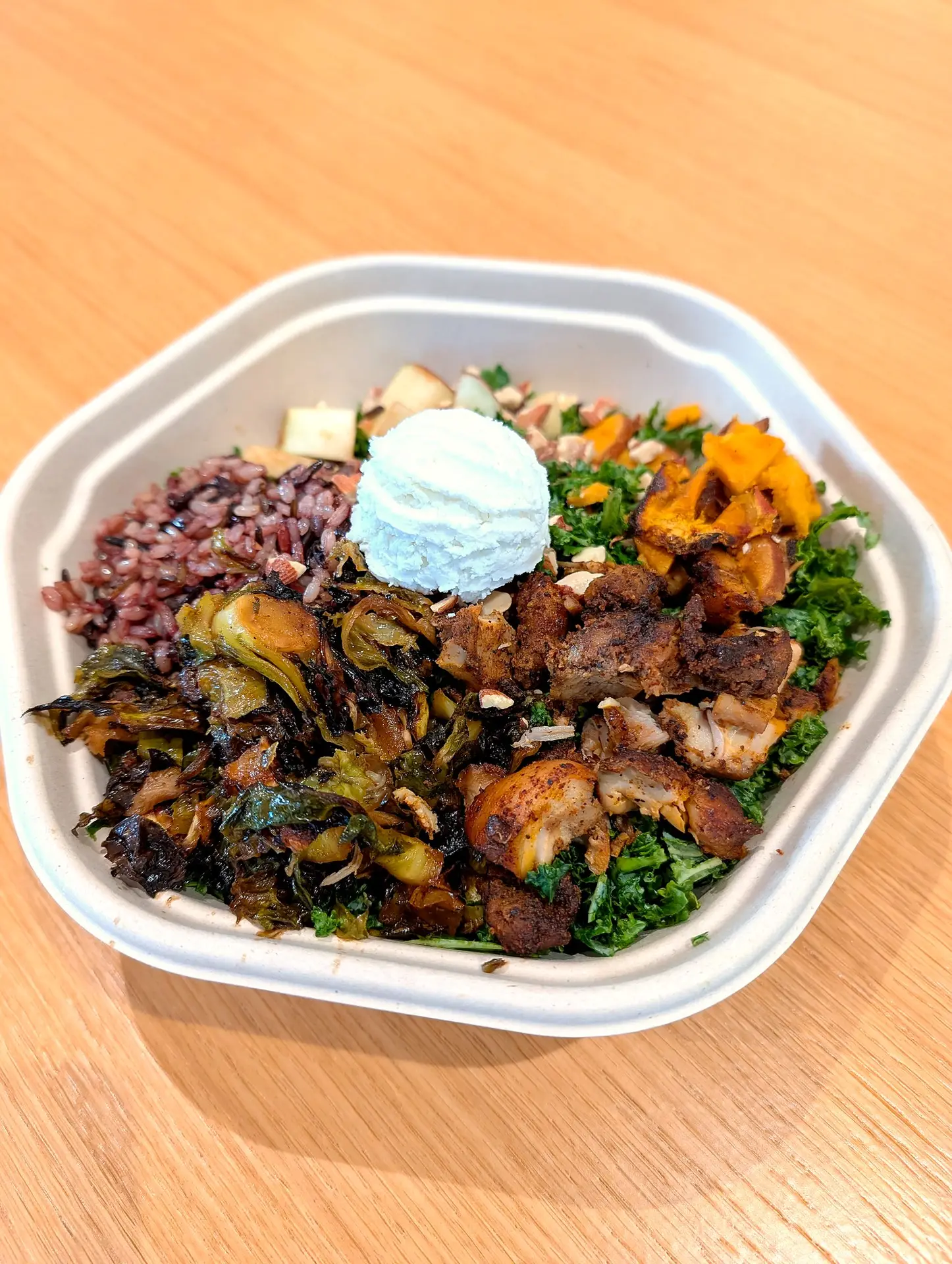 Sweetgreen Harvest Bowl topped with a scoop of FireFly Farms Fresh Goat Cheese